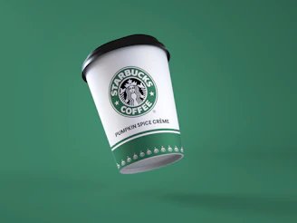 a starbucks coffee cup flying through the air