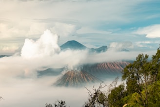 a view of a mountain covered in clouds