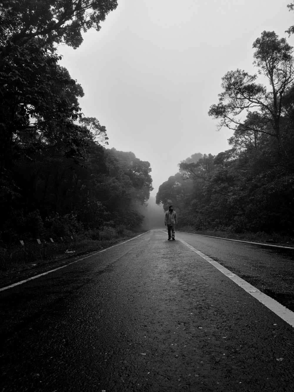 a person standing on the side of a road