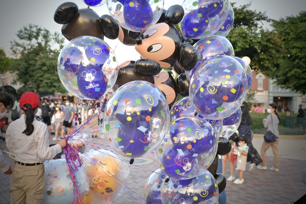 a bunch of balloons with mickey mouse on them