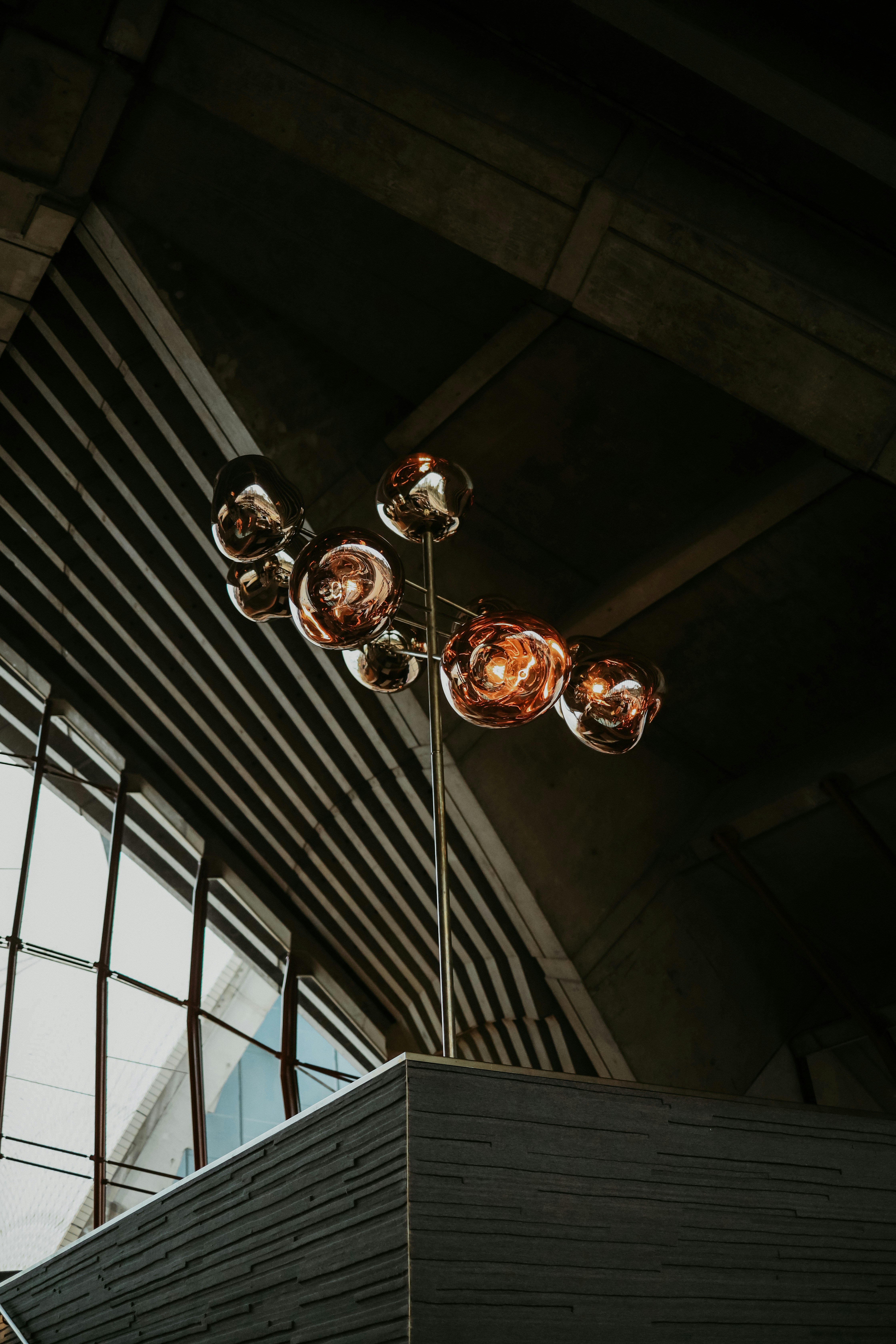 a tall light fixture sitting next to a window