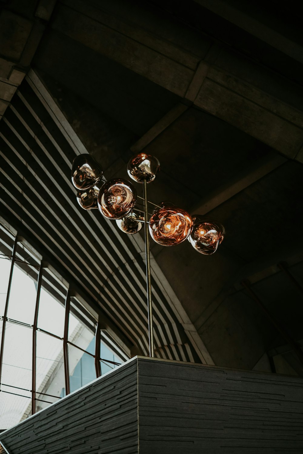 a tall light fixture sitting next to a window