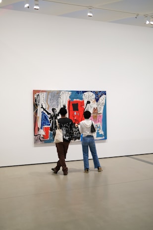 Close-up of a visitor admiring a vibrant abstract painting in the gallery.