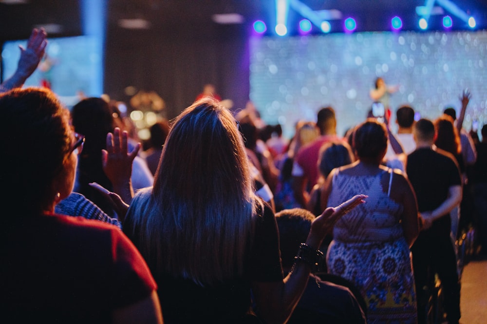 a group of people standing in front of a stage