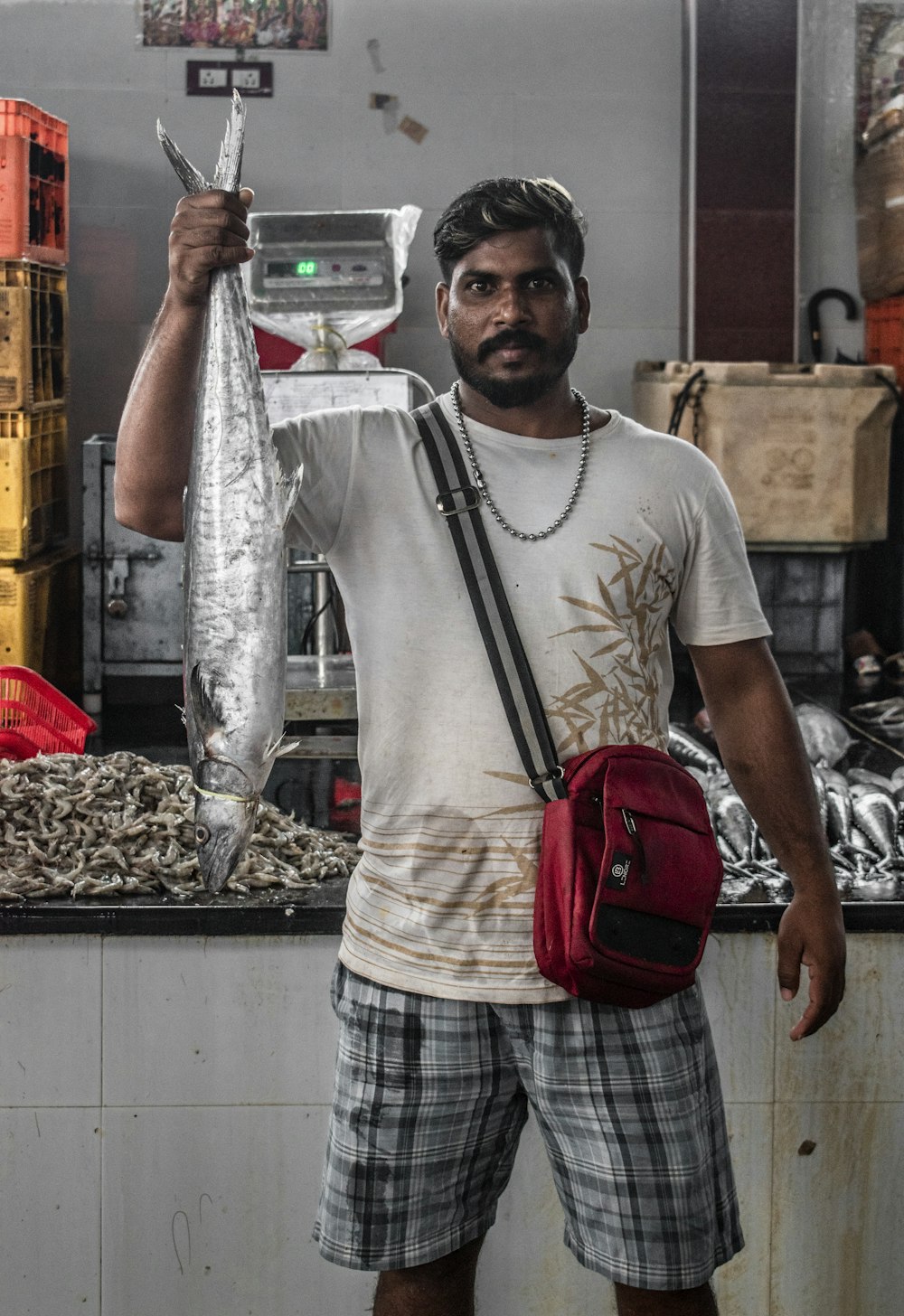 a man holding a fish in his right hand