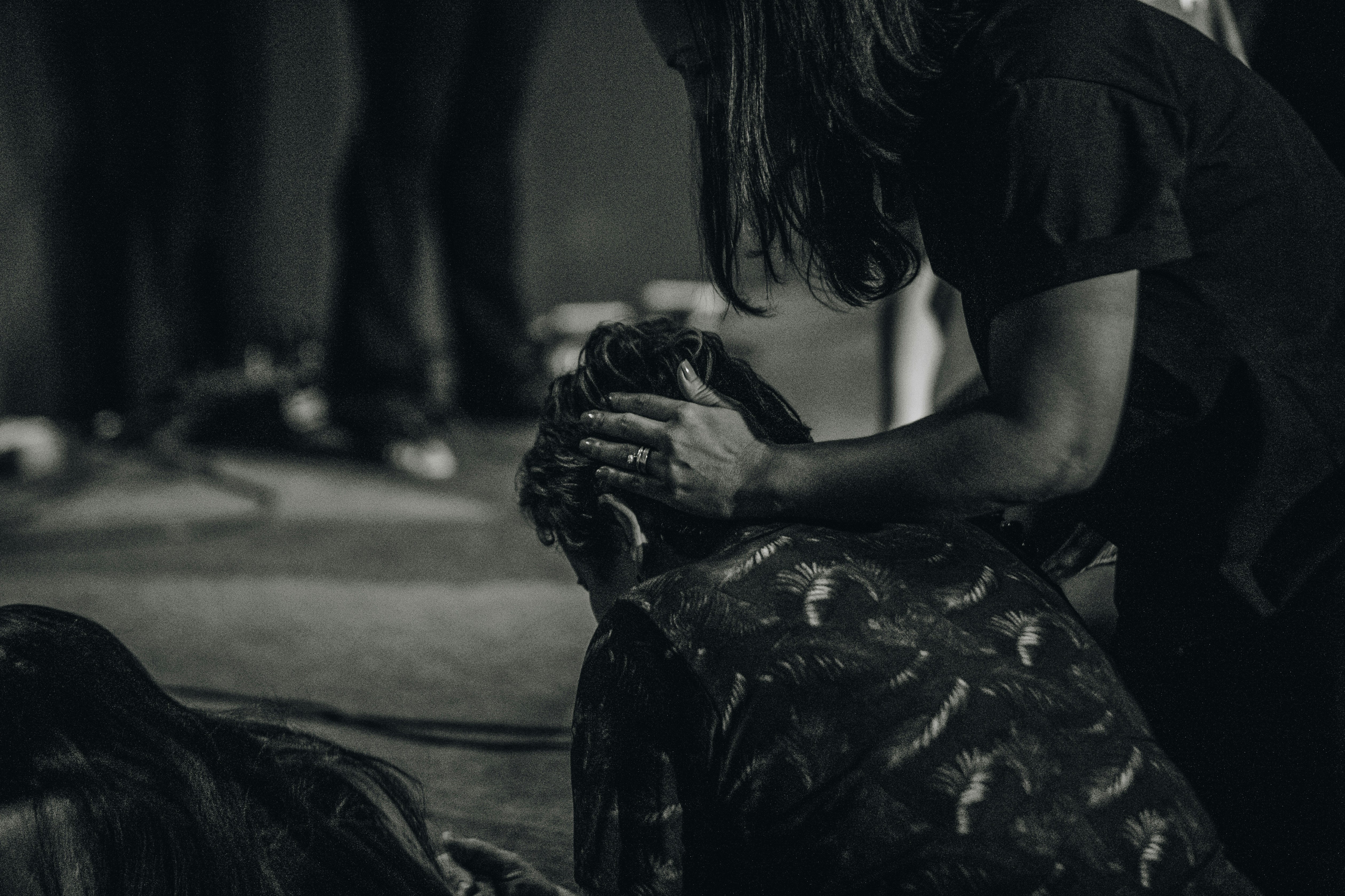a woman sitting on the floor holding a cat