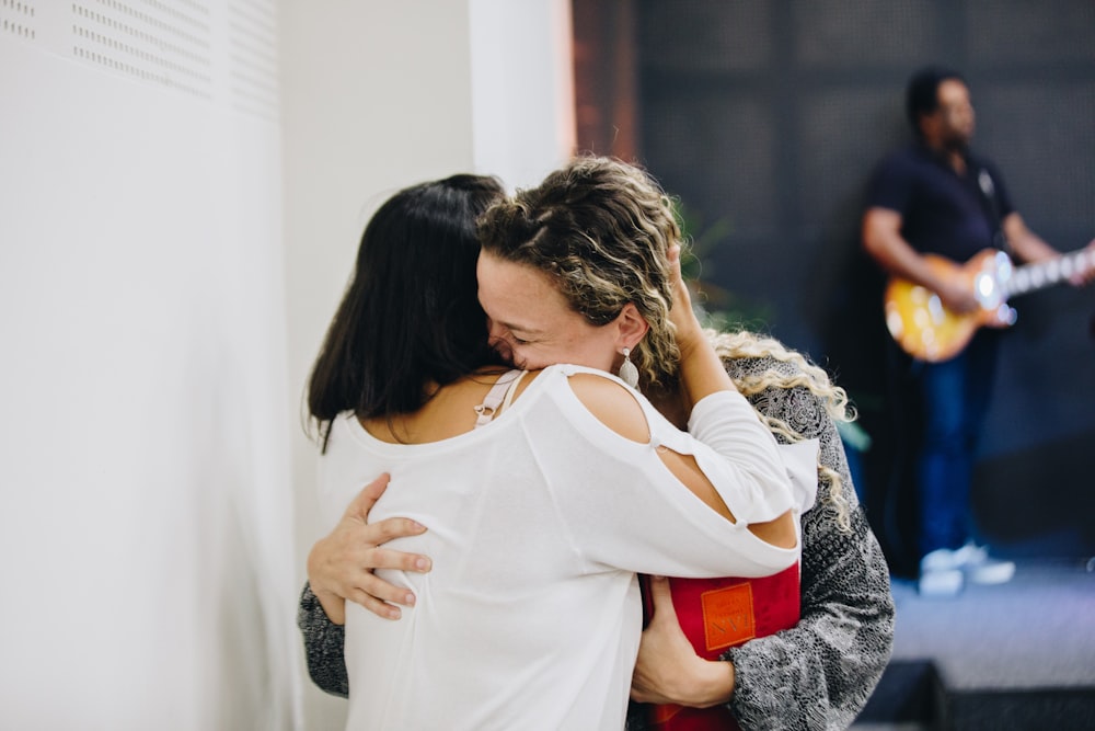 a couple of people that are hugging each other