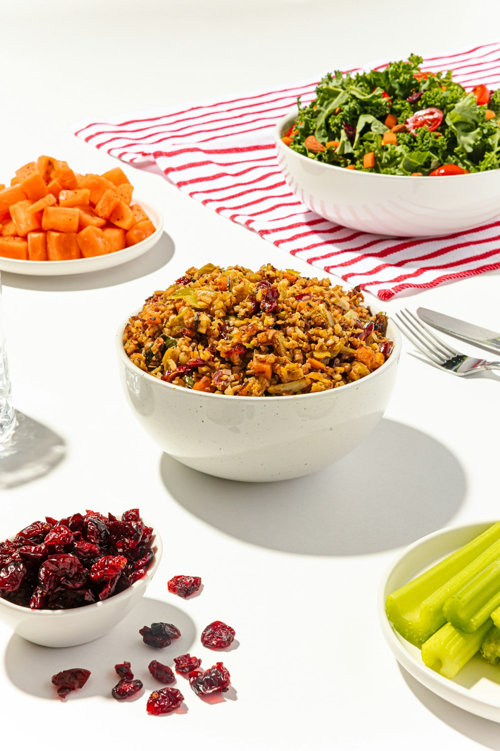 a white table topped with bowls of food