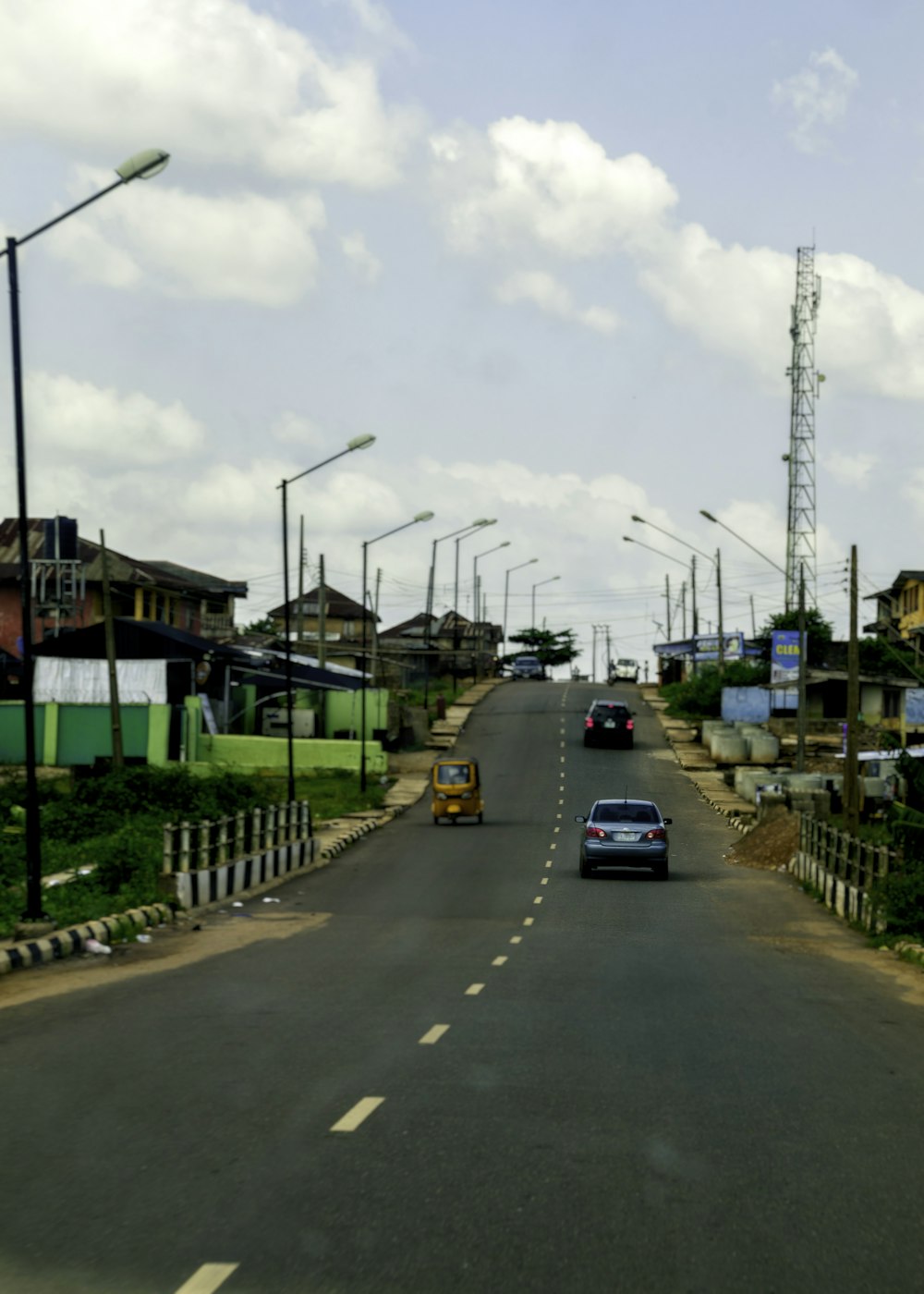 a car driving down a street next to tall buildings