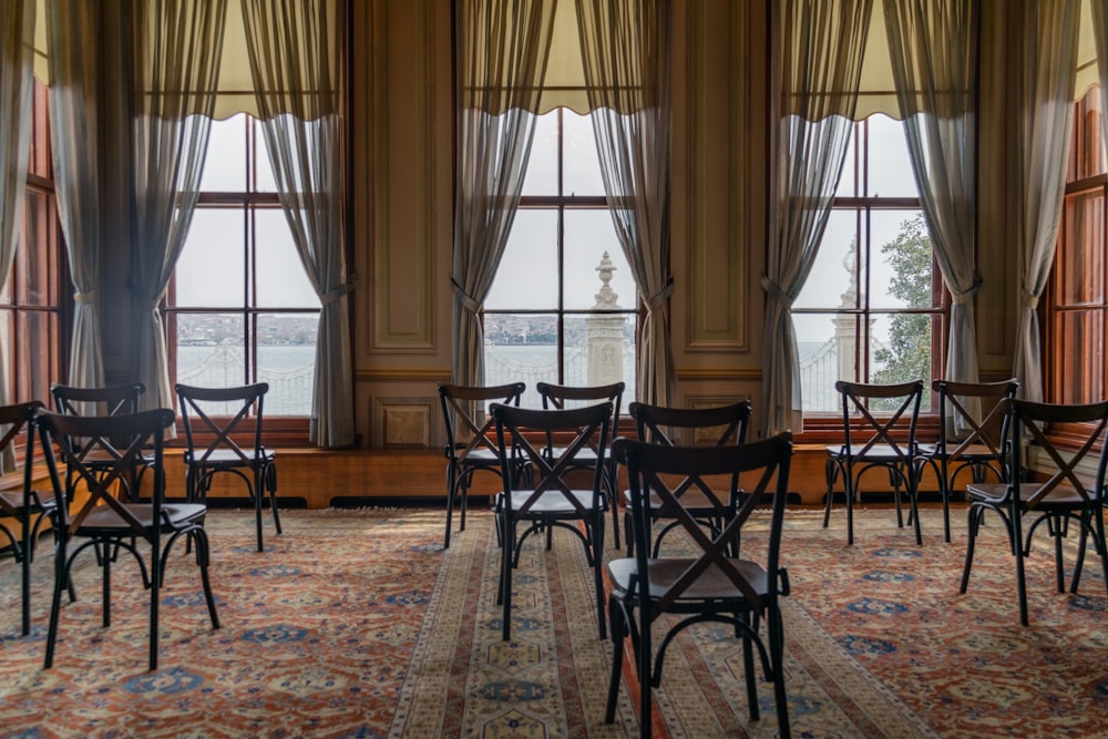 a room filled with lots of windows and chairs