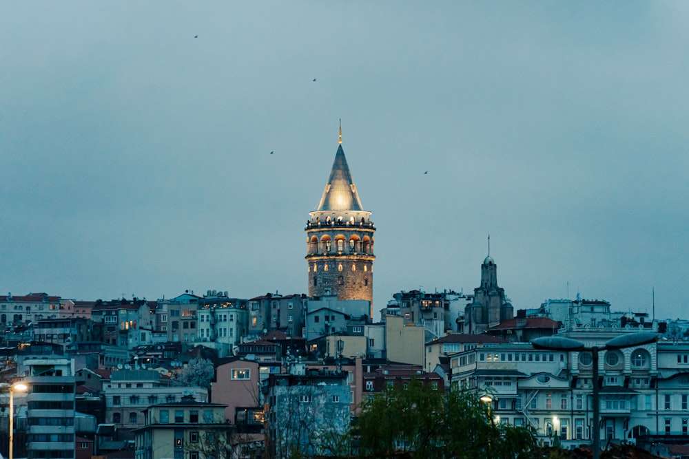 a very tall clock tower towering over a city