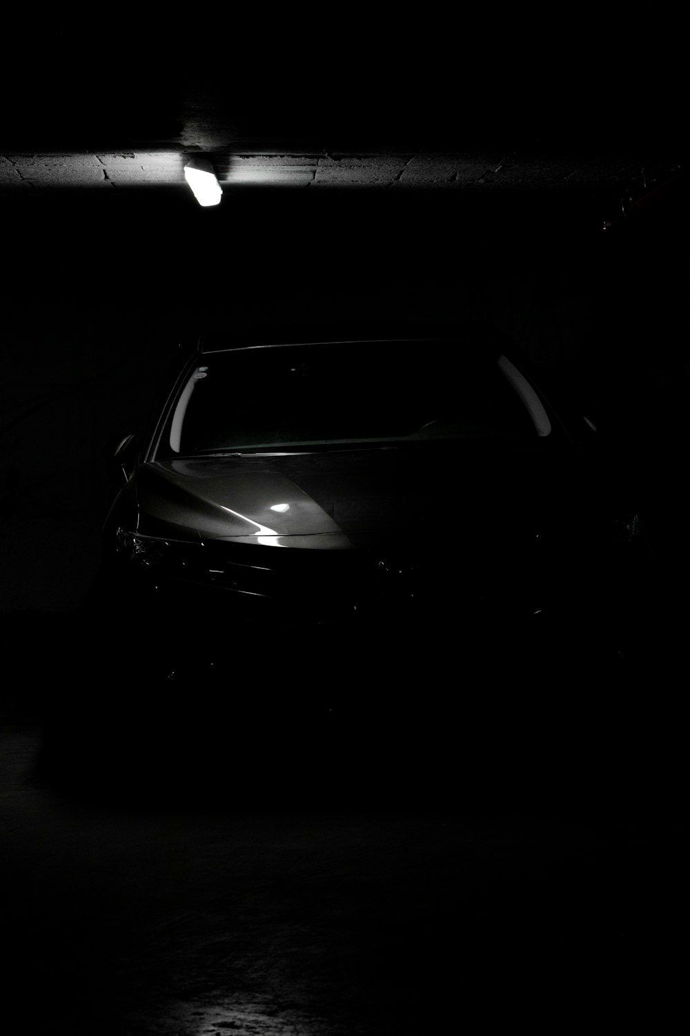 a car is parked in a dark garage