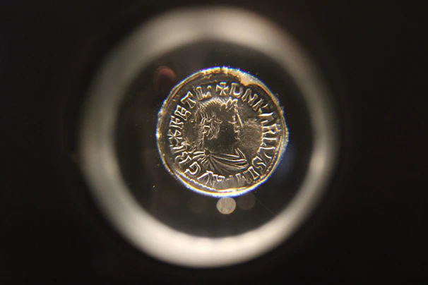 Macro shot capturing the fine engravings on a replica medieval coin.