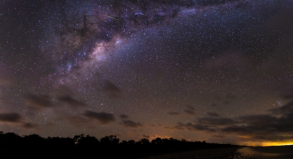 a view of the night sky from a beach