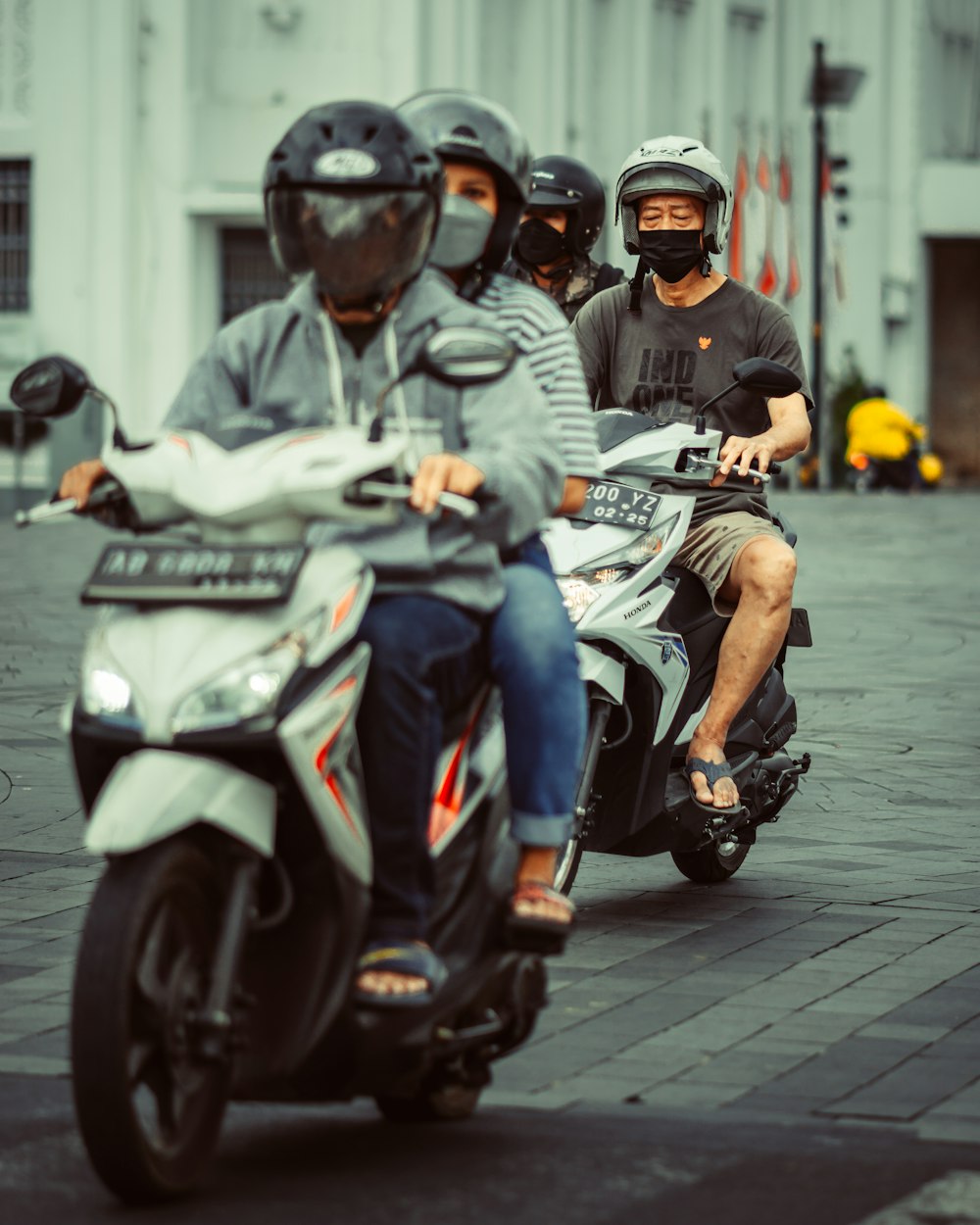 a group of people riding on the back of a motorcycle