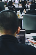 A professional office environment with a team collaborating on software development.