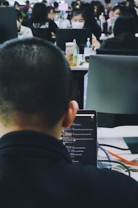 Modern office workspace with team collaborating on software development.