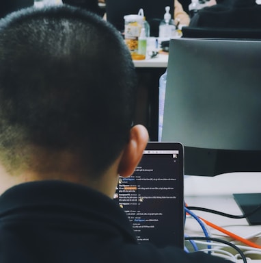 a man sitting in front of a laptop computer