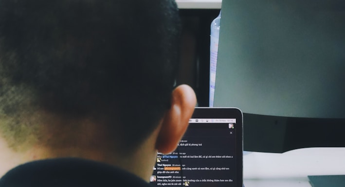 a man sitting in front of a laptop computer