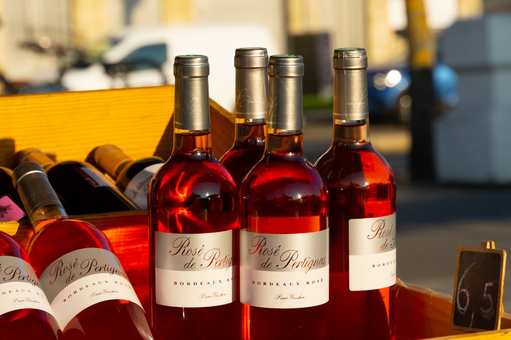 three bottles of wine are sitting in a crate