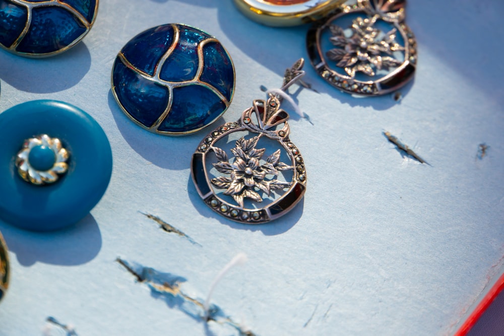 a collection of blue and gold jewelry sitting on top of a table