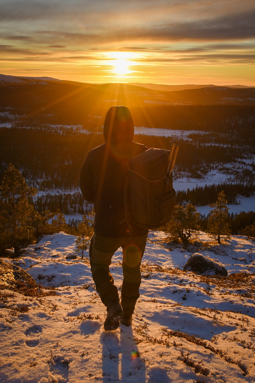 a man standing on top of a snow covered slope