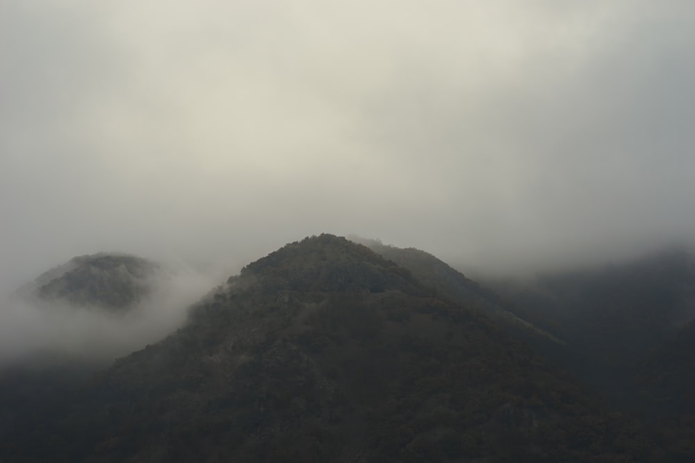 a mountain covered in fog and low lying clouds