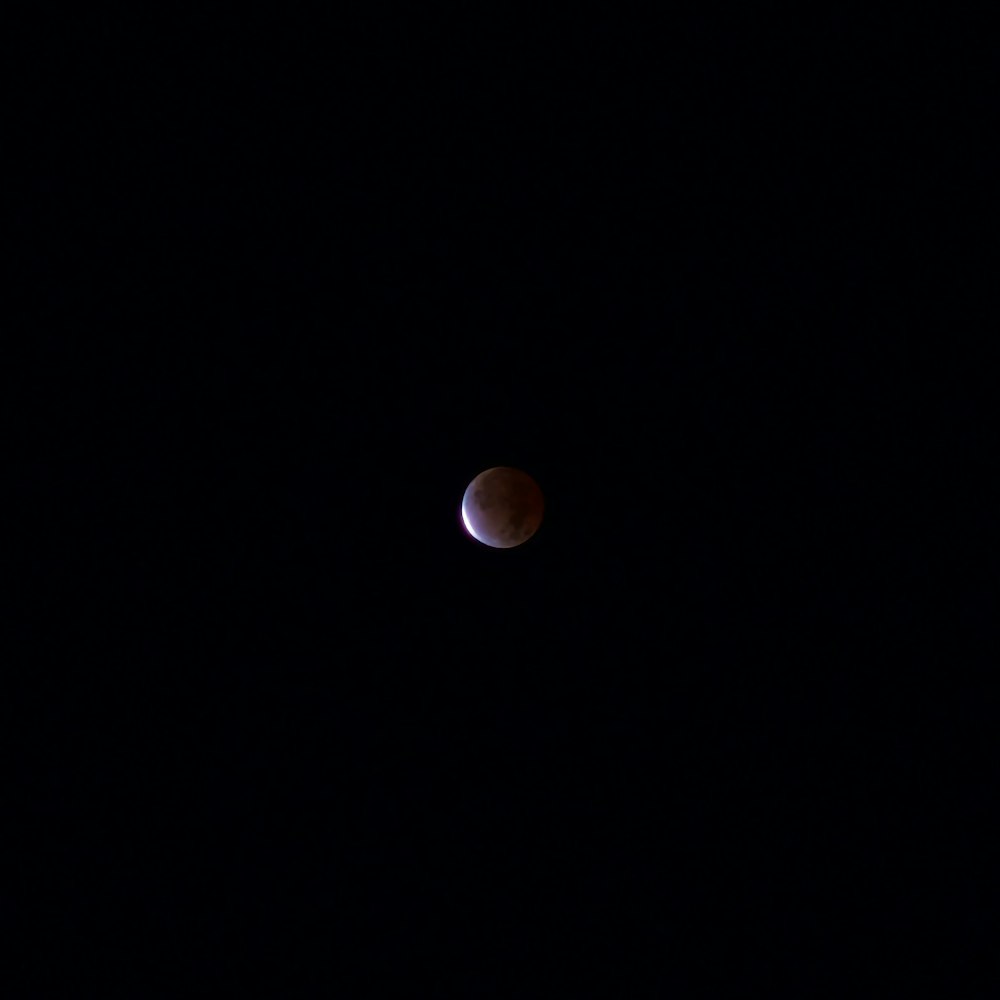 a half moon is seen in the dark sky