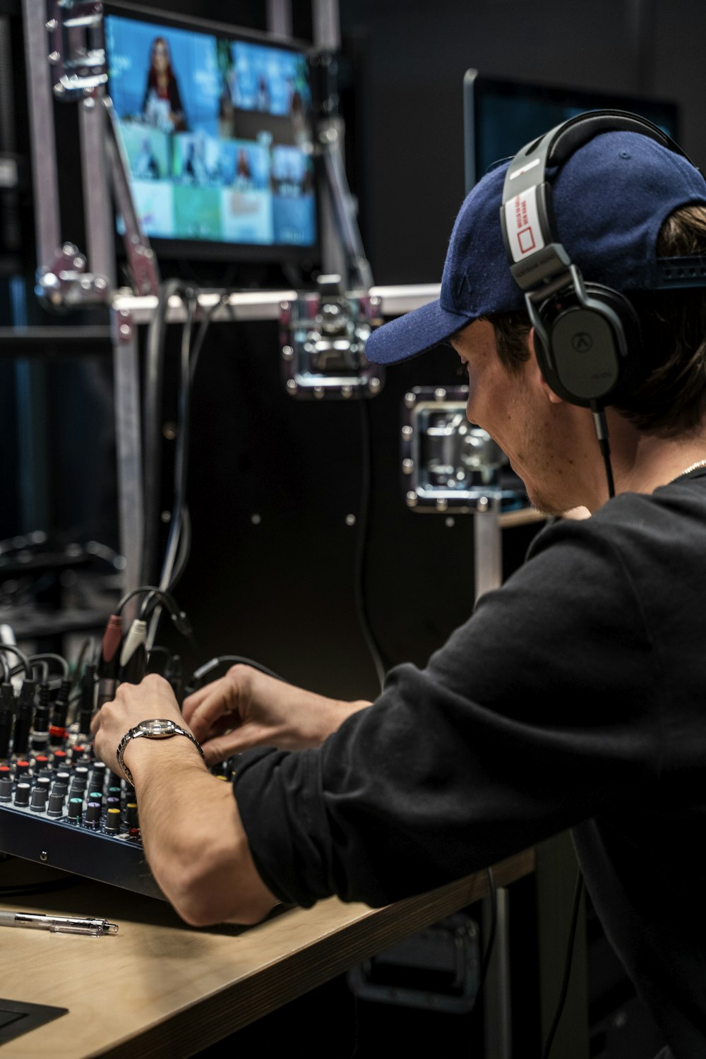 a man wearing headphones is working on a keyboard