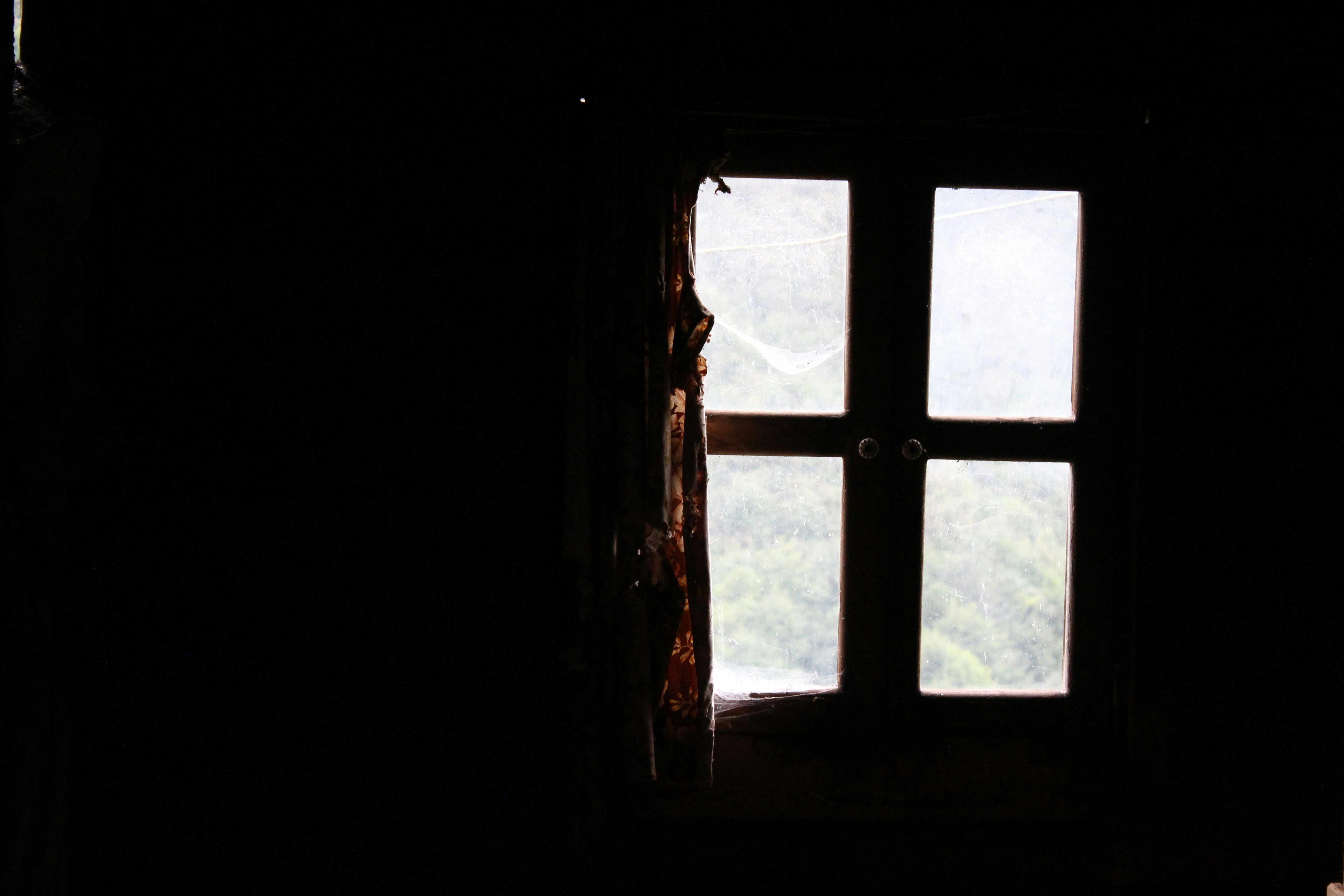 A dark room with a window and a curtain photo Free Window Image on