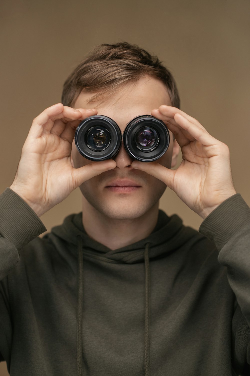 a man looking through a pair of binoculars