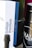 A close-up view of a box with the label 'Italian Pavilion' and some text related to the Mostra Internazionale d'Arte Cinematografica di Venezia, featuring a color-coded design. Beside the box, a dark cylindrical container is partially visible with the text 'MAÌA GARDA DOC' on it.