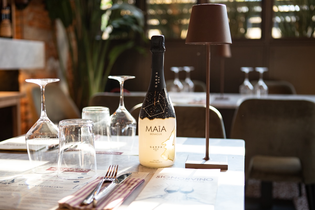 Intimate Italian dinner table setting with wine and warm candlelight at Trattoria Monti in the Rione Monti neighbourhood