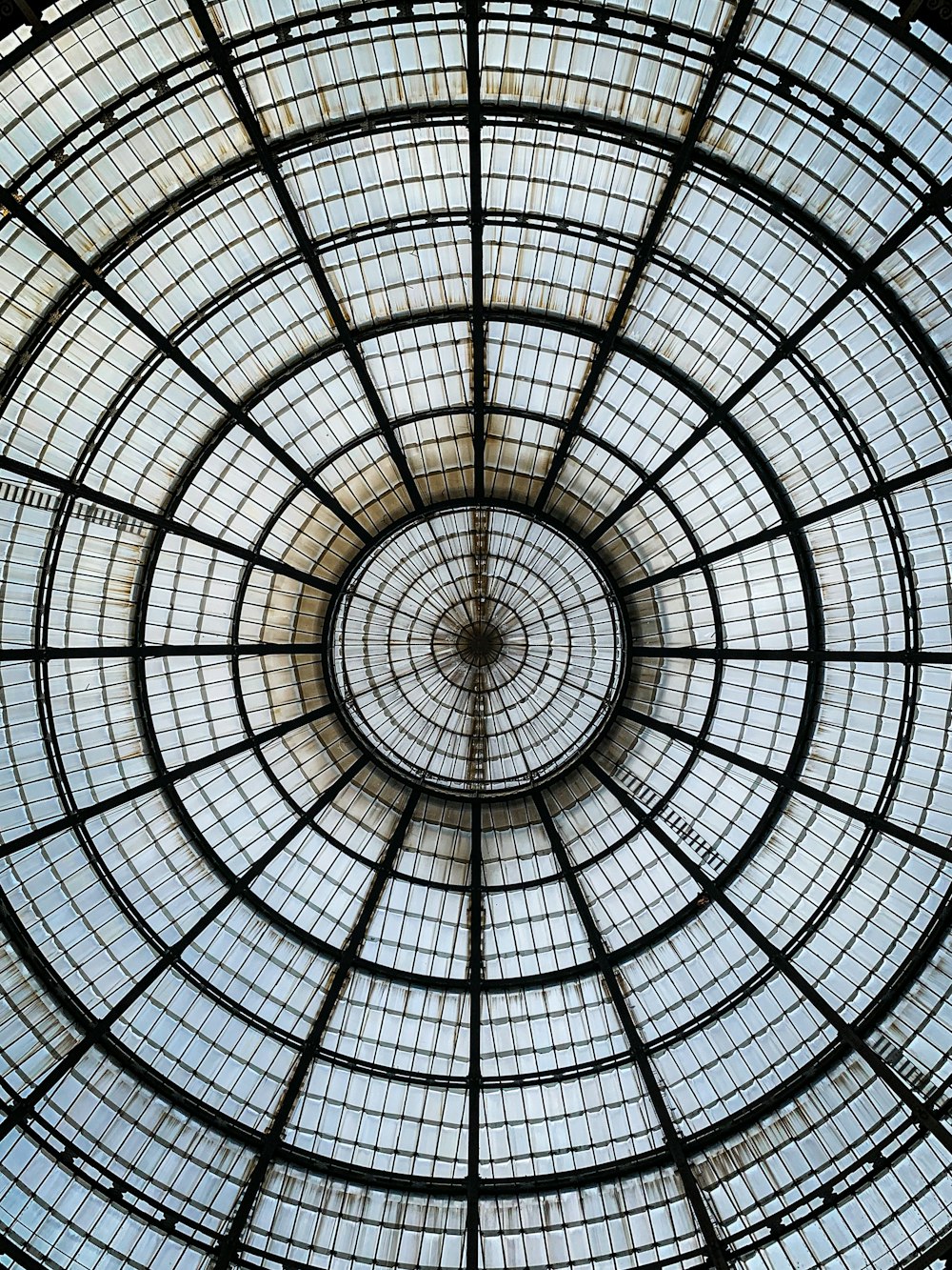 a glass ceiling with a circular design in the center