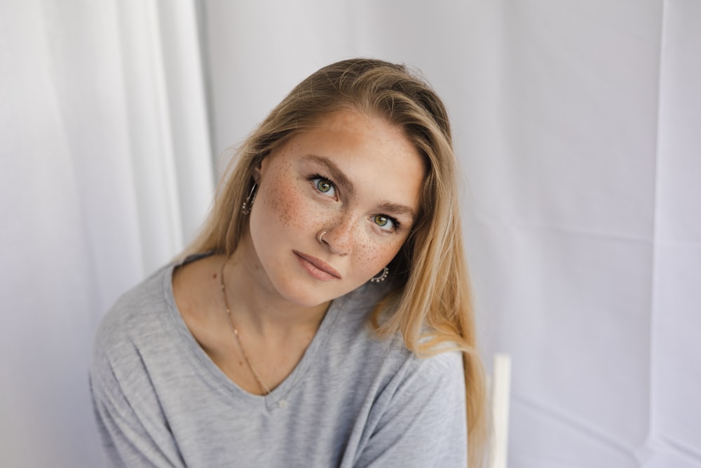 a woman with freckled hair is posing for a picture