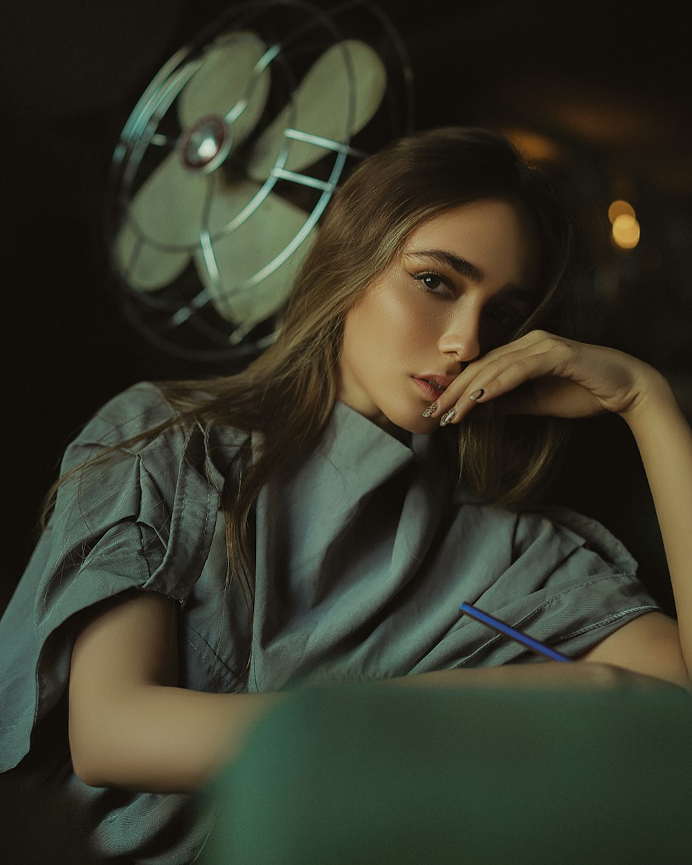 a woman sitting in front of a movie projector