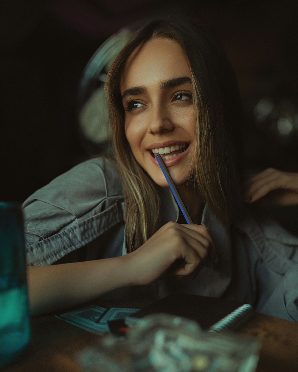 a woman smiles as she brushes her teeth