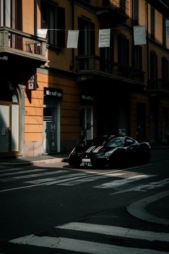 a couple of cars parked on the side of a road