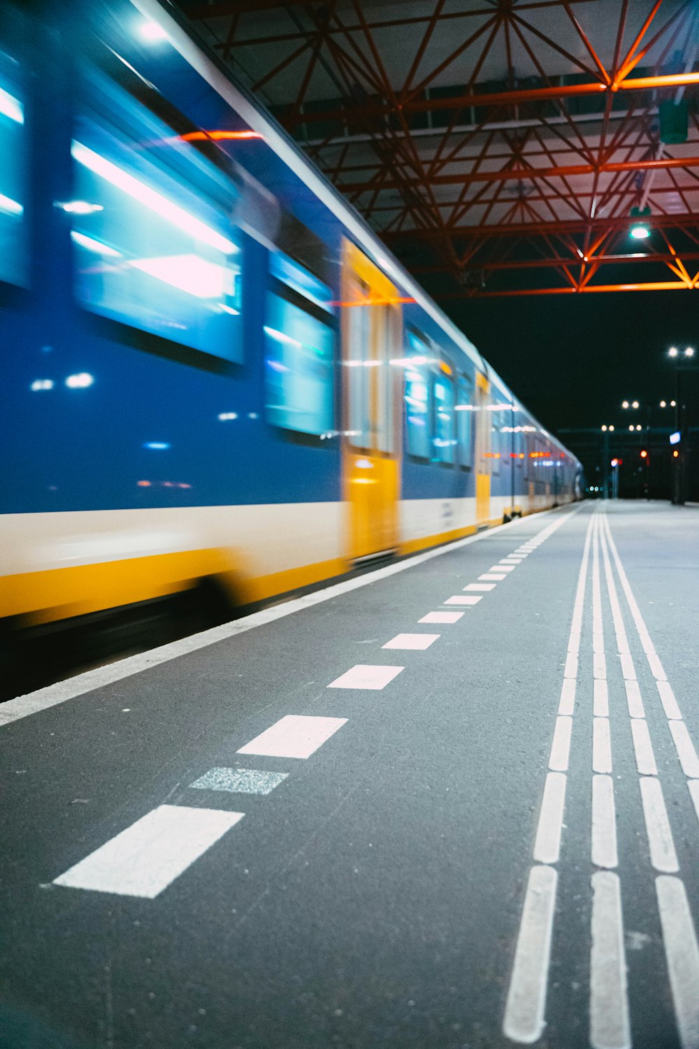 a train traveling down tracks next to a train station