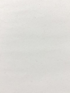 a black and white photo of a person on a surfboard