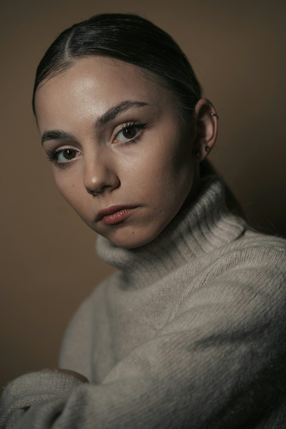 a woman in a turtle neck sweater posing for a picture
