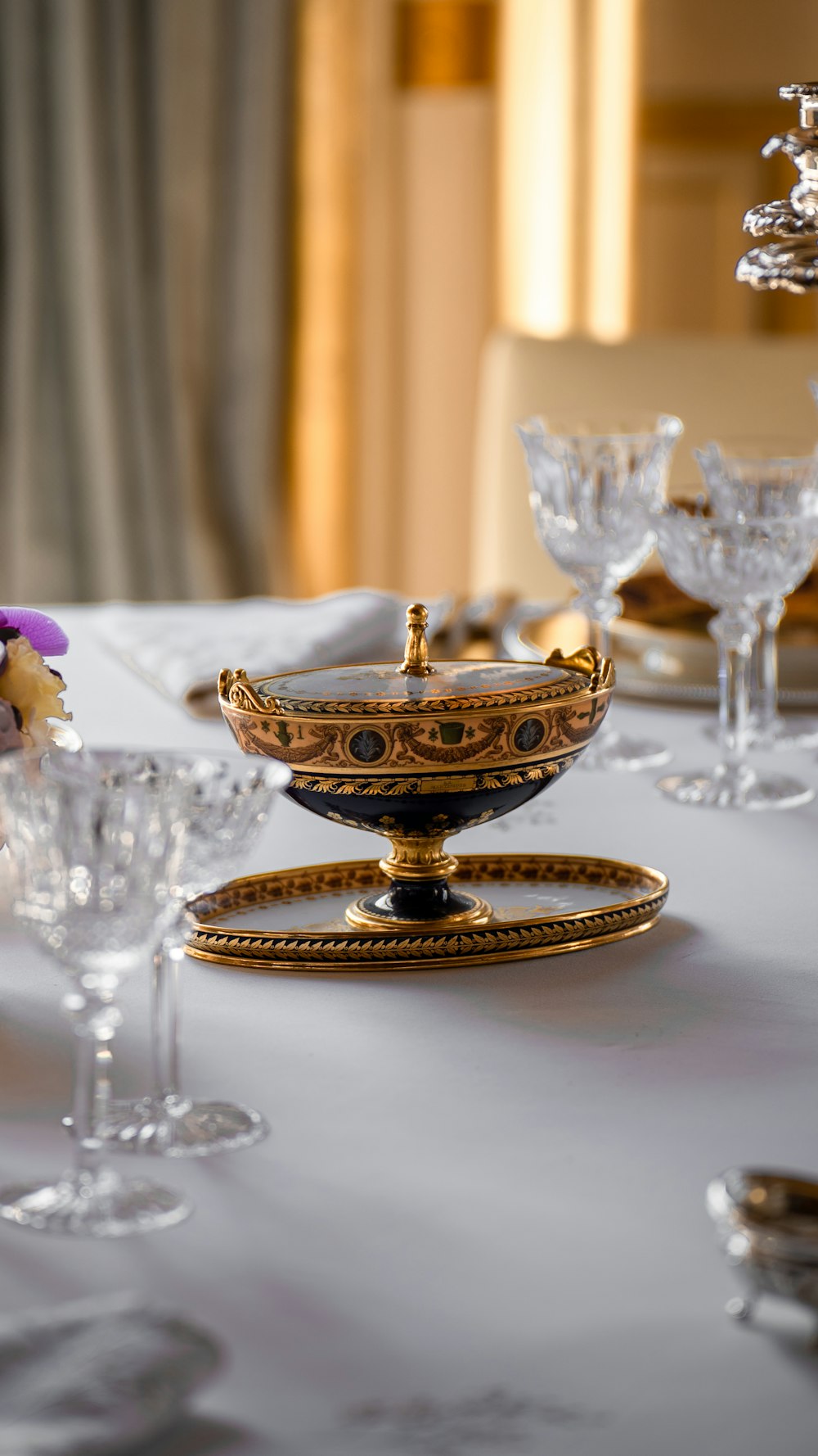 a table topped with lots of glasses and plates