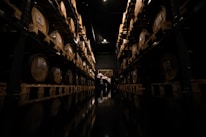 a dark room with lots of wine barrels