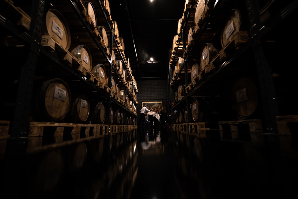 a dark room with lots of wine barrels