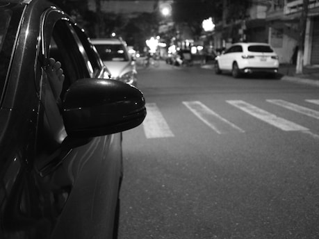 a car parked on the side of a street at night