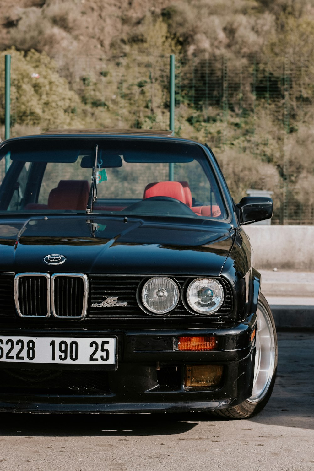 a black car parked on the side of the road