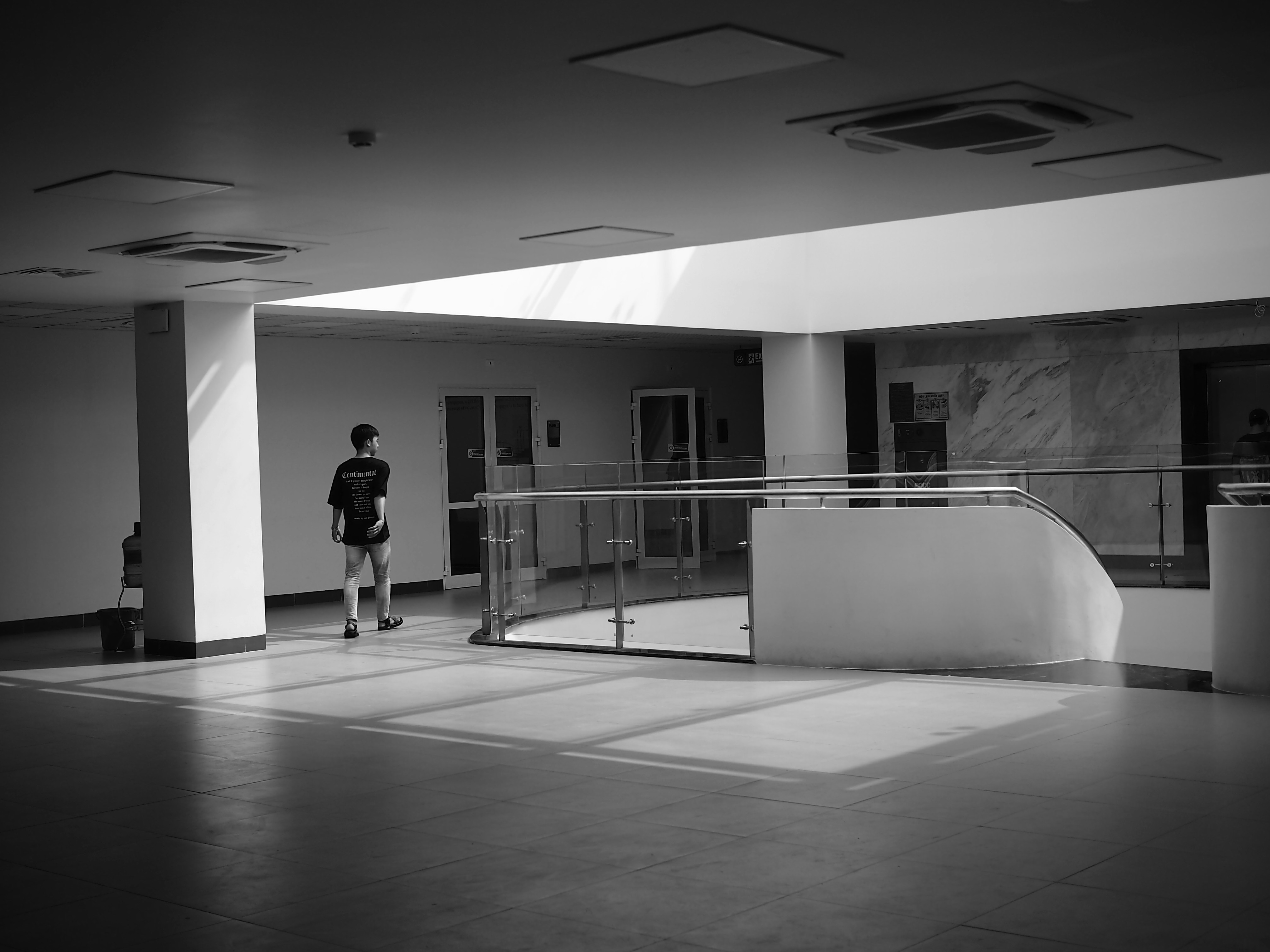 a person standing in a room with a railing