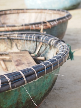 Close-up of traditional caiçara boat carved from wood, resting on the sand