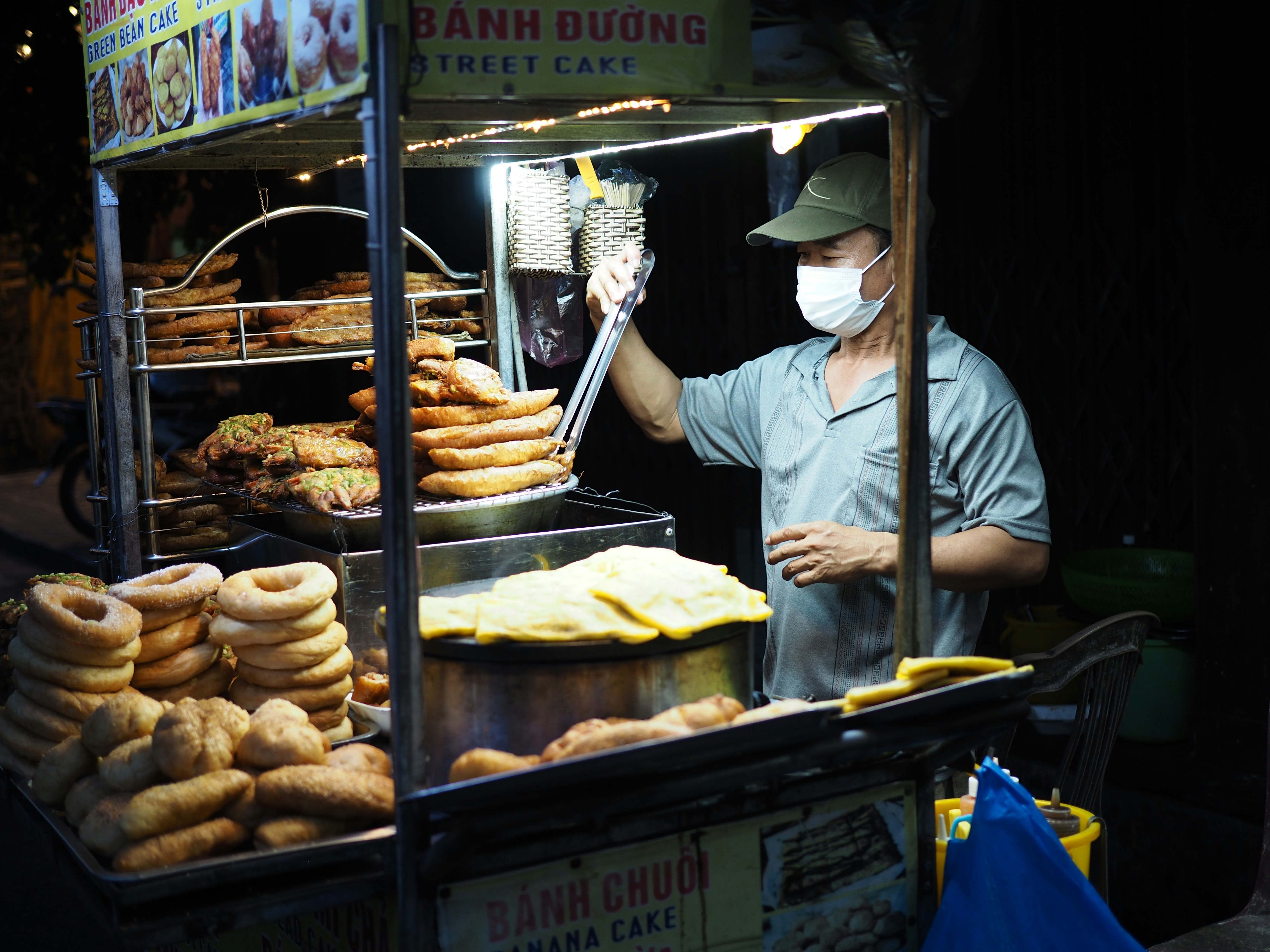 Vendor at a stall stacked with bagels