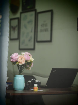 A minimalist workspace with floral designs and pastel decor elements.